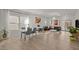 Bright living room with modern decor, fireplace, large windows, and hardwood floors at 1713 Wrenn Rd, Durham, NC 27703