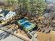 Aerial view of a well-maintained community tennis court surrounded by lush greenery at 1713 Wrenn Rd, Durham, NC 27703