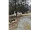 View of the backyard with the house, shed, a rock garden, and gravel driveway at 186 Frank Cash Rd, Timberlake, NC 27583