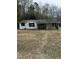 Charming single-story home with a covered front porch nestled among mature trees at 186 Frank Cash Rd, Timberlake, NC 27583