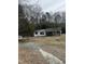 Exterior view of a one-story home with covered porch and mature trees at 186 Frank Cash Rd, Timberlake, NC 27583