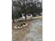 Quaint home surrounded by trees, featuring a gravel driveway and a cozy hammock for relaxation at 186 Frank Cash Rd, Timberlake, NC 27583