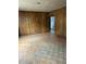 Spacious living room with worn wood paneling, ready for renovation and personalization at 186 Frank Cash Rd, Timberlake, NC 27583