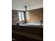 The room has wood paneling, multiple windows, and a ceiling fan at 186 Frank Cash Rd, Timberlake, NC 27583