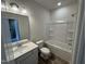 Well-lit bathroom featuring a shower-tub, vanity, and modern fixtures at 192 Bruce Dr, Dunn, NC 28334