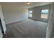 Bedroom featuring plush carpeting and two windows offering natural light at 192 Bruce Dr, Dunn, NC 28334