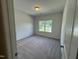 Empty bedroom with neutral carpet, a single window, and fresh paint at 192 Bruce Dr, Dunn, NC 28334