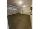 Spacious two car garage with concrete flooring and drywall awaiting painting at 192 Bruce Dr, Dunn, NC 28334