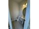 Compact half bathroom with tile floors, pedestal sink, and modern lighting at 192 Bruce Dr, Dunn, NC 28334