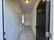 Bright hallway with neutral walls and light wood-look floors leads to other rooms in this new home at 192 Bruce Dr, Dunn, NC 28334