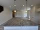 View of the kitchen island with granite countertop with the living room in the background at 192 Bruce Dr, Dunn, NC 28334