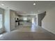 Bright, open-concept kitchen and living room with tile flooring, stainless appliances and island at 192 Bruce Dr, Dunn, NC 28334