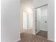 Hallway with neutral-toned walls and carpet with doorway view of closet with washer and dryer hookups at 192 Bruce Dr, Dunn, NC 28334