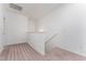 This carpeted hallway includes a handrail, and nearby is the air vent at 192 Bruce Dr, Dunn, NC 28334