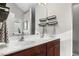 Bright bathroom featuring double sinks, wood cabinets, and a large mirror at 201 Timber Meadow Lk, Fuquay Varina, NC 27526