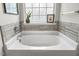 Relaxing bathroom featuring a soaking tub and decorative details at 201 Timber Meadow Lk, Fuquay Varina, NC 27526