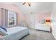 Cheerful bedroom with light pink walls, a ceiling fan, and a large window offering great light at 201 Timber Meadow Lk, Fuquay Varina, NC 27526