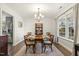 Elegant dining room with a chandelier, a china cabinet, and large window view at 201 Timber Meadow Lk, Fuquay Varina, NC 27526