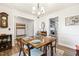 Elegant dining room with a chandelier, a china cabinet, and large window view with easy kitchen access at 201 Timber Meadow Lk, Fuquay Varina, NC 27526