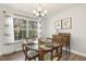 Dining room features a wood table, chairs, and large window letting in natural light at 201 Timber Meadow Lk, Fuquay Varina, NC 27526