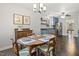 Dining room with wood table and chairs, open to updated kitchen with stainless steel appliances at 201 Timber Meadow Lk, Fuquay Varina, NC 27526