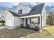 Charming two-story home with a well-manicured lawn, attached garage, and a cozy front porch sitting area at 201 Timber Meadow Lk, Fuquay Varina, NC 27526