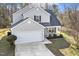 Charming two-story home featuring a two-car garage, covered porch, and manicured landscaping, creating a welcoming curb appeal at 201 Timber Meadow Lk, Fuquay Varina, NC 27526