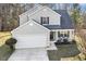 Charming two-story home with two-car garage and a covered porch with a seating area, inviting relaxation and curb appeal at 201 Timber Meadow Lk, Fuquay Varina, NC 27526