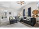Cozy living room with a sectional sofa, large windows, and neutral decor at 201 Timber Meadow Lk, Fuquay Varina, NC 27526