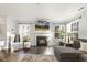 Bright living room featuring a fireplace with flatscreen TV and large windows at 201 Timber Meadow Lk, Fuquay Varina, NC 27526