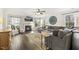 Bright and airy living room featuring a fireplace, ceiling fan, and large windows at 201 Timber Meadow Lk, Fuquay Varina, NC 27526