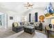 Comfortable living room featuring a sectional sofa, TV, and natural light at 201 Timber Meadow Lk, Fuquay Varina, NC 27526