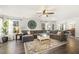 Spacious living room with large sectional sofa, modern decor, and hardwood floors at 201 Timber Meadow Lk, Fuquay Varina, NC 27526