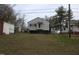 Exterior view of home with sheds in the background on a grassy lot at 2110 Carolina Mill Rd, Burlington, NC 27217