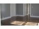 Hallway featuring hardwood floors and white trim at 2110 Carolina Mill Rd, Burlington, NC 27217