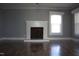 Bright living room featuring a fireplace with white mantle and gorgeous hardwood floors at 2110 Carolina Mill Rd, Burlington, NC 27217