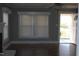 Open living room featuring bright windows, ceiling fan and beautiful hardwood floors at 2110 Carolina Mill Rd, Burlington, NC 27217