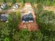 Overhead view of a newly built home on a lot surrounded by lush greenery at 215 Purslane Dr, Franklinton, NC 27525