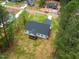 Aerial view of house with a screened in back porch surrounded by lush greenery at 215 Purslane Dr, Franklinton, NC 27525