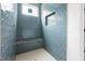 Modern bathroom shower with blue hexagon tile, bench and built-in niche at 215 Purslane Dr, Franklinton, NC 27525