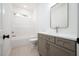 Well-lit bathroom featuring a shower-tub combo, and a vanity with gray cabinets and a white countertop at 215 Purslane Dr, Franklinton, NC 27525