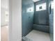 Tiled bathroom features a window, a built-in seat, and an open doorway for easy access at 215 Purslane Dr, Franklinton, NC 27525