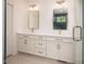 Bathroom with double sink vanity with two mirrors and grey cabinets with white quartz countertops at 215 Purslane Dr, Franklinton, NC 27525