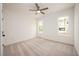 Bright, neutral bedroom featuring plush carpet, two windows and a ceiling fan at 215 Purslane Dr, Franklinton, NC 27525