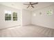 Bedroom with large windows, plush neutral carpet, and ceiling fan at 215 Purslane Dr, Franklinton, NC 27525