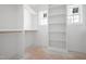 Walk-in closet with white shelving and hanging rods for ample storage at 215 Purslane Dr, Franklinton, NC 27525