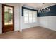 Elegant dining room featuring wainscoting, a modern chandelier, and natural light from large windows at 215 Purslane Dr, Franklinton, NC 27525