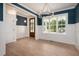 Stylish dining room with wainscoting, modern lighting, and large windows offering backyard views at 215 Purslane Dr, Franklinton, NC 27525