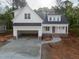 Charming two-story home with a large driveway and an attached two-car garage at 215 Purslane Dr, Franklinton, NC 27525