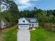 Exterior view of two-story home with a two-car garage and landscaped front yard at 215 Purslane Dr, Franklinton, NC 27525